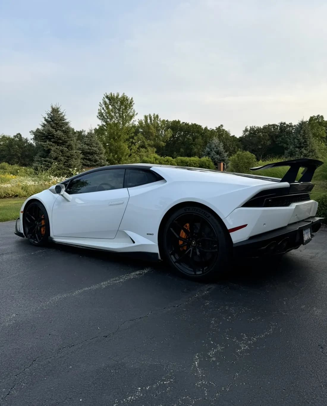 White Lamborghini Huracán with aftermarket wing after detailing