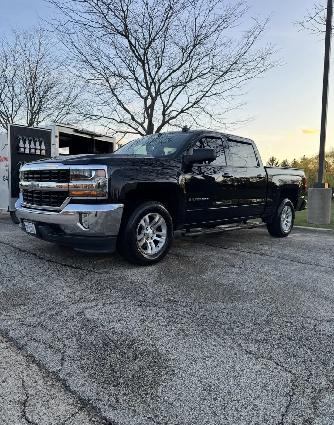 Black Chevrolet Silverado mobile-detailed on location at sunset