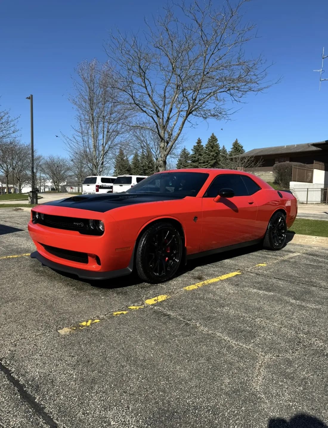 Orange Dodge Challenger SRT Hellcat with a mirror-gloss finish in the sun
